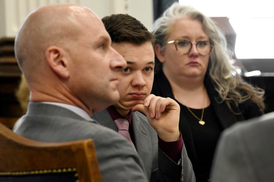 Kyle Rittenhouse, center, and his lawyers Corey Chirafisi and Natalie Wisco look on after a break in proceedings in his trial at the Kenosha County Courthouse in Kenosha, Wis., on Tuesday, Nov. 9, 2021. Rittenhouse is accused of killing two people and wounding a third during a protest over police brutality in Kenosha, last year. (Mark Hertzberg/Pool Photo via AP) ORG XMIT: WIPO303