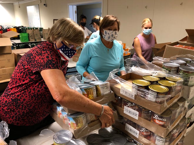 Volunteers sort food for Beaches Emergency Assistance Ministries' annual Thanksgiving meal basket program.