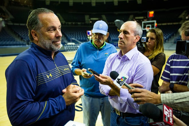 Notre Dame head coach Mike Brey talks with reporters including John Fineran and Tom Noie during men's basketball media day Wednesday, Oct. 13, 2021 at Purcell Pavilion in South Bend.