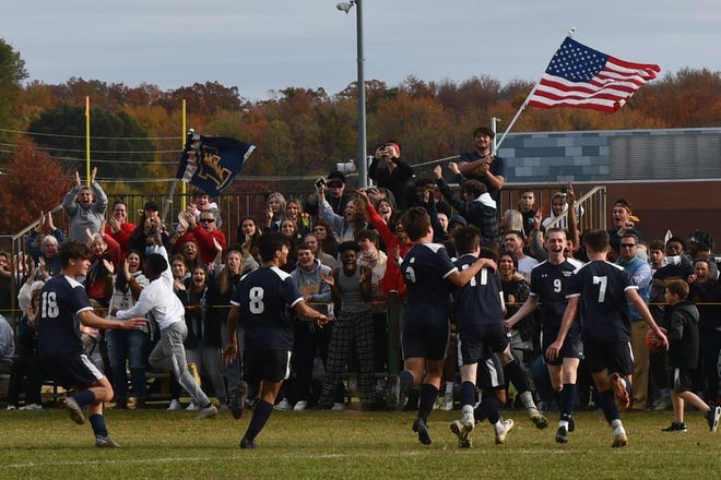 The Florence boys soccer team rushes over to ward the student section to celebrate their first goal against Middlesex