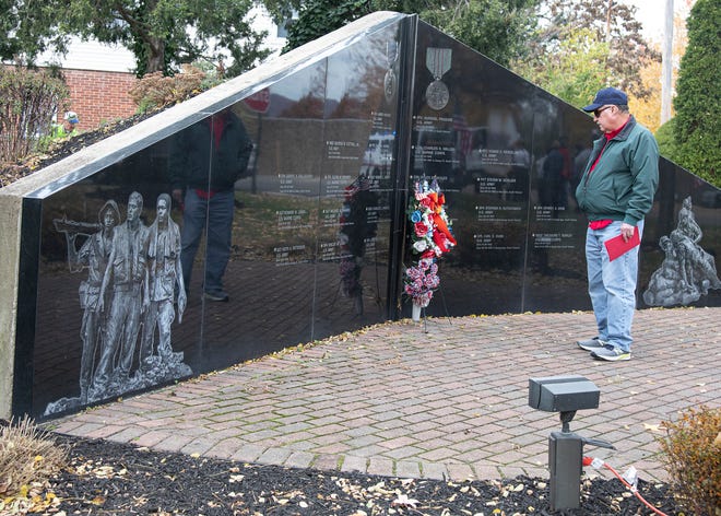 Dwight Fowler reads the wall in Veteran’s Park after a ceremony on Nov. 11, 2021. 