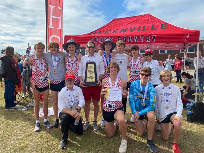 The Greenville High School boys cross country team poses with thei Class AAAA state championship trophy on Nov. 11, 2021 in Columbia. The Red Raiders beat out Catawba Ridge for the first place trophy.
