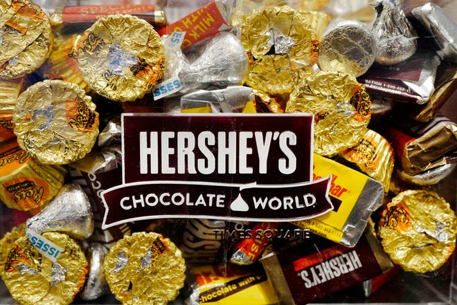 FILE - A mixture of Hershey's chocolates is displayed in the company's Times Square store, Wednesday, March 1, 2017, in New York. Hershey is expanding its salty snack portfolio with the purchase of Dotâ€™s Homestyle Pretzels. The Hershey Co. said Wednesday, Nov. 10, 2021, that it will spend $1.2 billion for North Dakota-based Dotâ€™s Pretzels as well as Pretzels Inc., an Indiana-based manufacturer of Dotâ€™s Pretzels that operates three plants. (AP Photo/Mark Lennihan, File)
