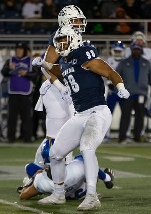 Nevada defensive end Sam Hammond (98) reacts after getting a sack against San Jose State on Nov. 6. The win that night was the Wolf Pack's seventh of the season.
