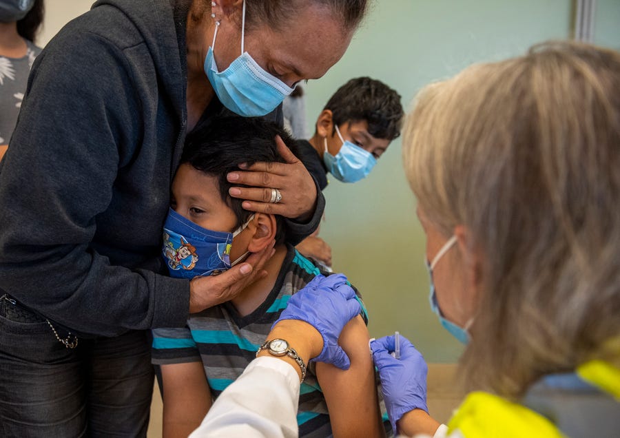 Aaron Zavala, is held by his grandmother during the Pfizer pediatric COVID-19 vaccine clinic for children 5-11 years old inside the Greenfield Community Center in Greenfield, Calif., on Wednesday, Nov. 10, 2021.