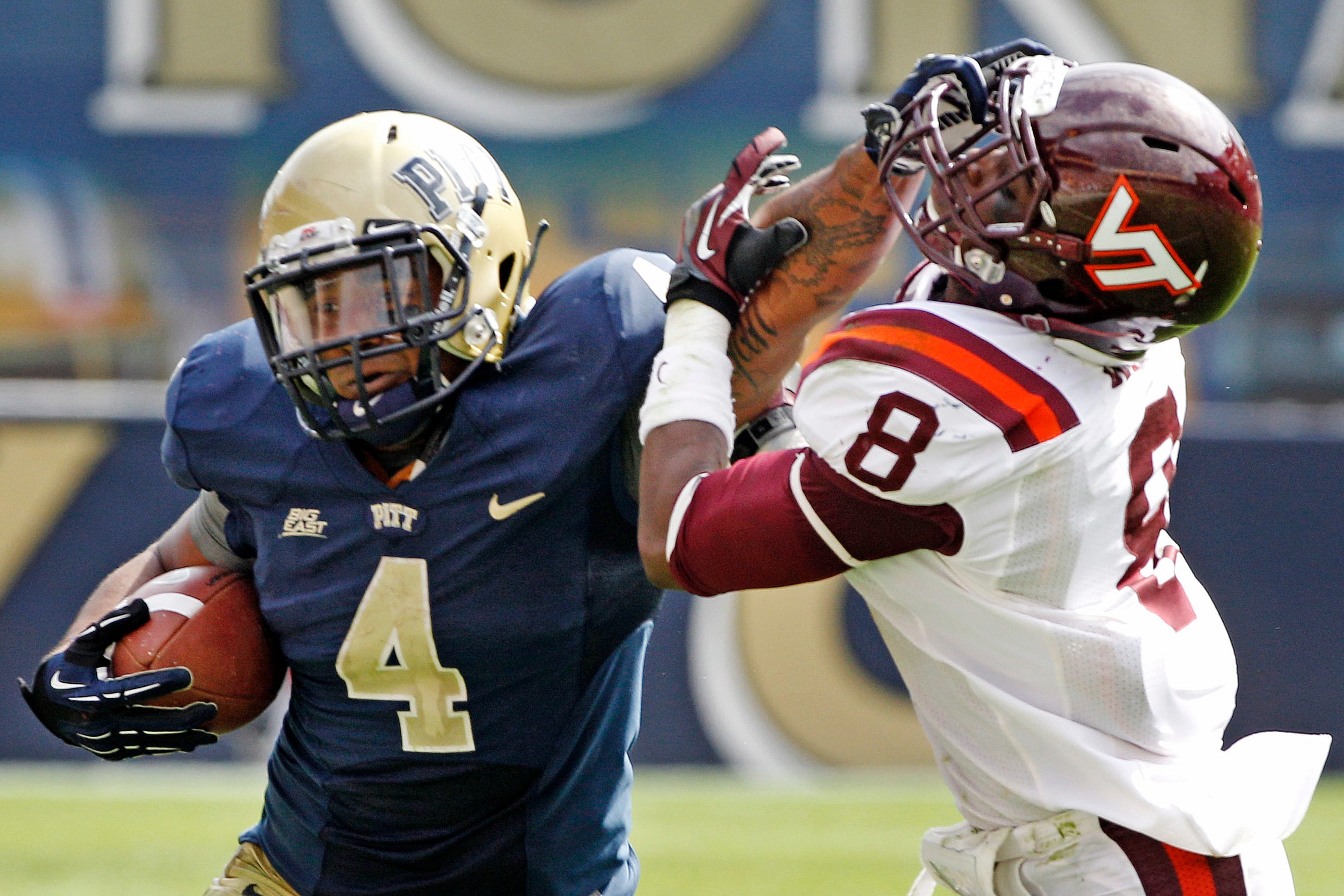 Pittsburgh running back Rushel Shell (4) stiff-arms Virginia Tech safety Detrick Bonner (8) during a game in 2012.