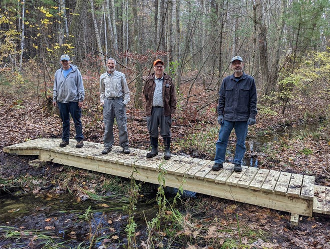 Sudbury Valley Trustees collaborated with the Berlin Conservation Commission to install a bridge and formalize a trail that connects two main routes within the Forty Caves Conservation Area in Berlin and Clinton. SVT volunteers Jim Makuc, Ken Appel, Dean Briggs and Jim Shelhamer stand over the recently completed bridge.