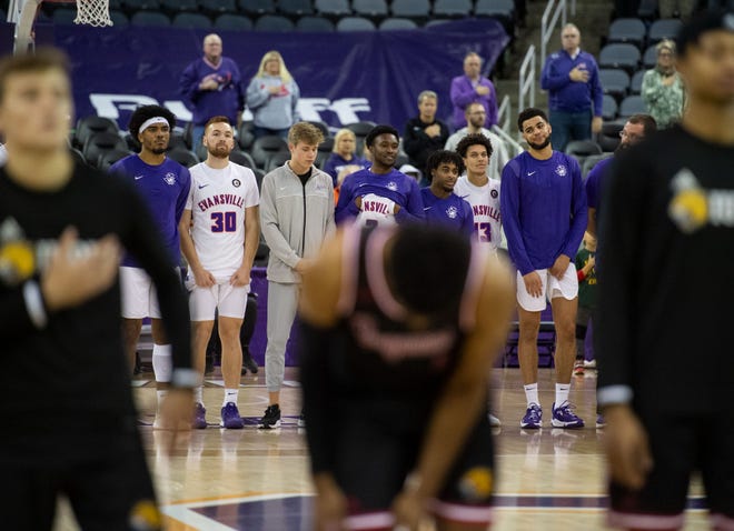 The Purple Aces stand for the national anthem before the basketball game between the University of Evansville Purple Aces and the Indiana University-Purdue University Indianapolis Jaguars in Evansville, Ind., Thursday evening, Nov. 11, 2021. 