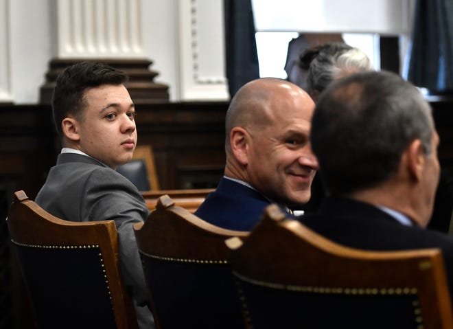 Kyle Rittenhouse looks back as he sits with his attorneys before the day starts at the Kenosha County Courthouse on November 12, 2021 in Kenosha, Wisconsin.