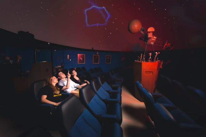 Guests watch a show at Adrian College's Robinson Planetarium.