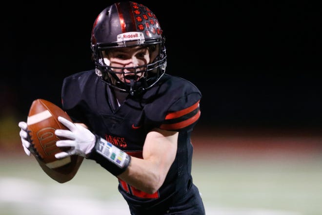 Rossville junior Kade Perine makes a catch from senior Torrey Horak last season.