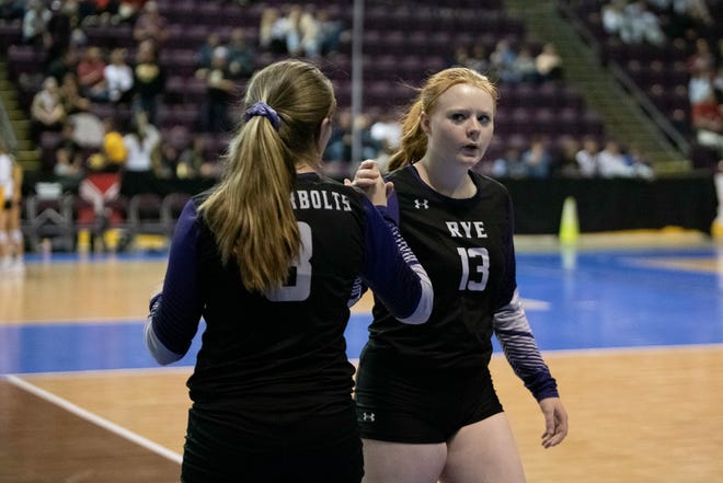 Rye High School's Jaklyn Newitt, left, subs in for teammate Kaitlyn Taylor during the third day matchup with Holyoke at the Class 2A state girls volleyball tournament on Saturday, November 13, 2021.