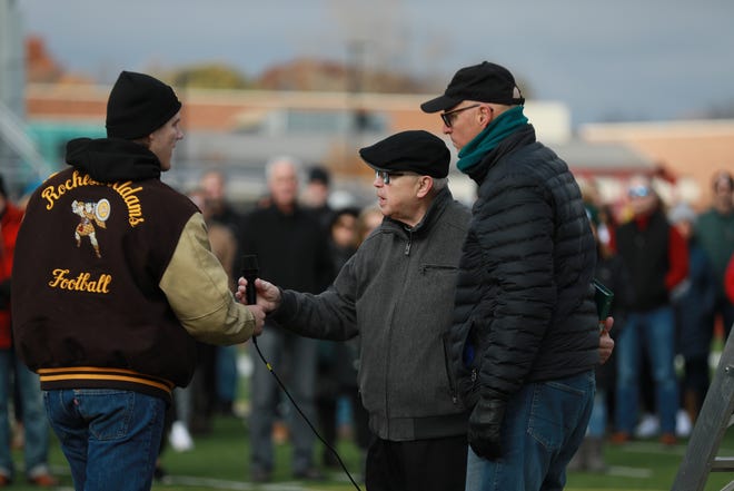 Jacob Turner, 18, of Rochester receives the microphone from Monsignor Mike Hrydziuszko to sing a song of praise during the prayer vigil for Brendan Santo, while Kensington Church's Founding Pastor Steve Andrews stands near on the football field at Rochester Adams High School on Nov. 13, 2021. Police in East Lansing have been searching for Brendan Santo for nearly two weeks. Santo, a Grand Valley State University student was last seen leaving Yakeley Hall on foot just before midnight on Oct. 29, according to Michigan State University police and suspect Santo may have been walking to the Brody neighborhood and do not believe he left the East Lansing area.