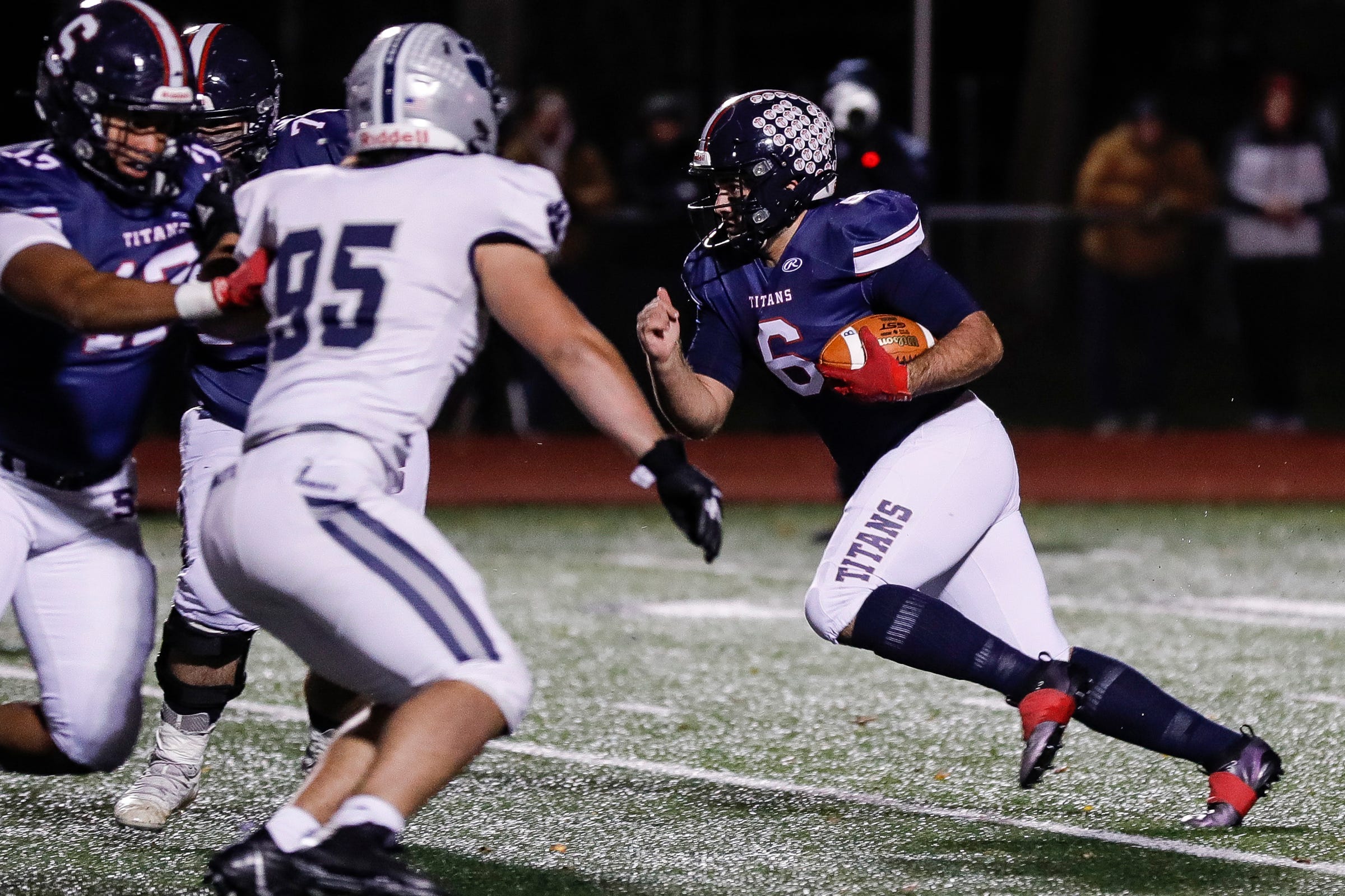 Sterling Heights Stevenson quarterback Biagio Madonna runs against Macomb Dakota during the first half at Stevenson High School in Sterling Heights on Friday, Nov. 12, 2021.
