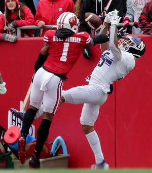 Wisconsin cornerback Faion Hicks breaks up a pass intended for Northwestern wide receiver Stephon Robinson Jr. on Saturday.