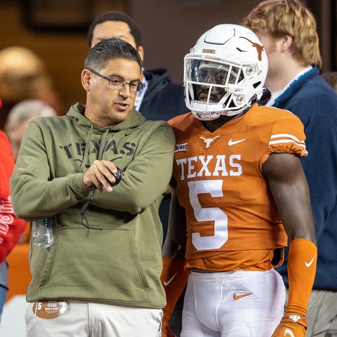 Texas assistant head coach Jeff Banks speaks with 