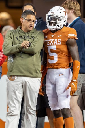 Texas assistant coach Jeff Banks speaks with defensive back and return man D'Shawn Jamison before a game last season. Banks coaches UT's special teams and tight ends; he's one of six assistant coaches who are set to receive an additional year tacked on to their current contracts.