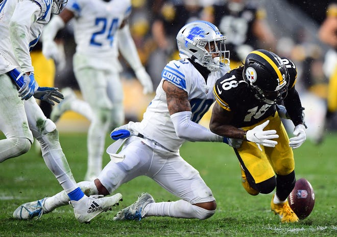 Steelers WR Diontae Johnson fumbles the ball in overtime during of the Lions' 16-16 tie with the Steelers on Sunday, Nov. 14, 2021, in Pittsburgh.