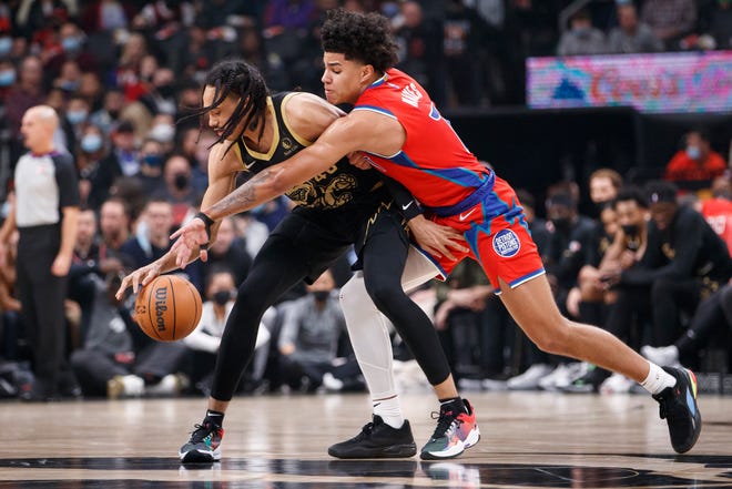 Dalano Banton of the Toronto Raptors keeps the ball away from Killian Hayes of the Detroit Pistons during the first half of their NBA game at Scotiabank Arena on Nov. 13, 2021 in Toronto.