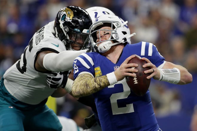 Indianapolis Colts quarterback Carson Wentz (2) scrambles while trying to get away from Jacksonville Jaguars defensive end Roy Robertson-Harris (95) on Sunday.