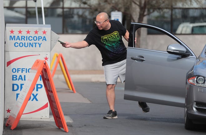 Phani Chigurupati drops a ballot off at the Maricopa County elections office in Phoenix on Nov. 1, 2020.