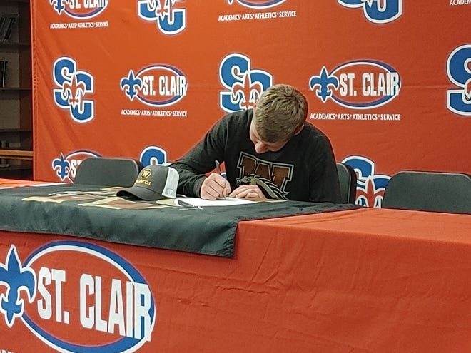 Derek Distelrath signs his letter of intent to play tennis for Western Michigan University at St. Clair High School on Friday, Nov. 12, 2021.