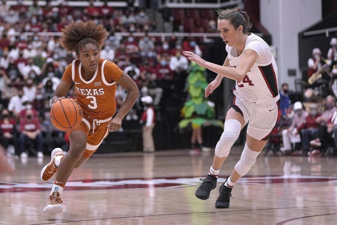 Texas guard Rori Harmon drives past Stanford's Lacie Hull during the Longhorns' upset victory Sunday in California. Texas is No. 12 in the country in this week's Top 25 poll, up from No. 25 last week.
