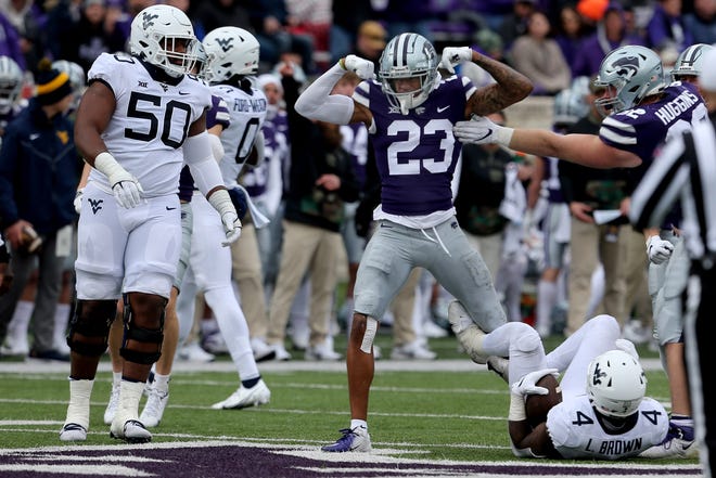 Kansas State cornerback Julius Brents (23) celebrates after tackling West Virginia's Leddie Brown (4) for a loss during the third quarter last Saturday at Bill Snyder Family Stadium. The Wildcats beat West Virginia, 34-17, for their fourth straight victory.