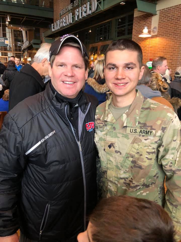 Eric Olson, left, and his son Evan at Green Bay's Lambeau Field in 2018 before Evan's Guard unit deployed to Afghanistan.