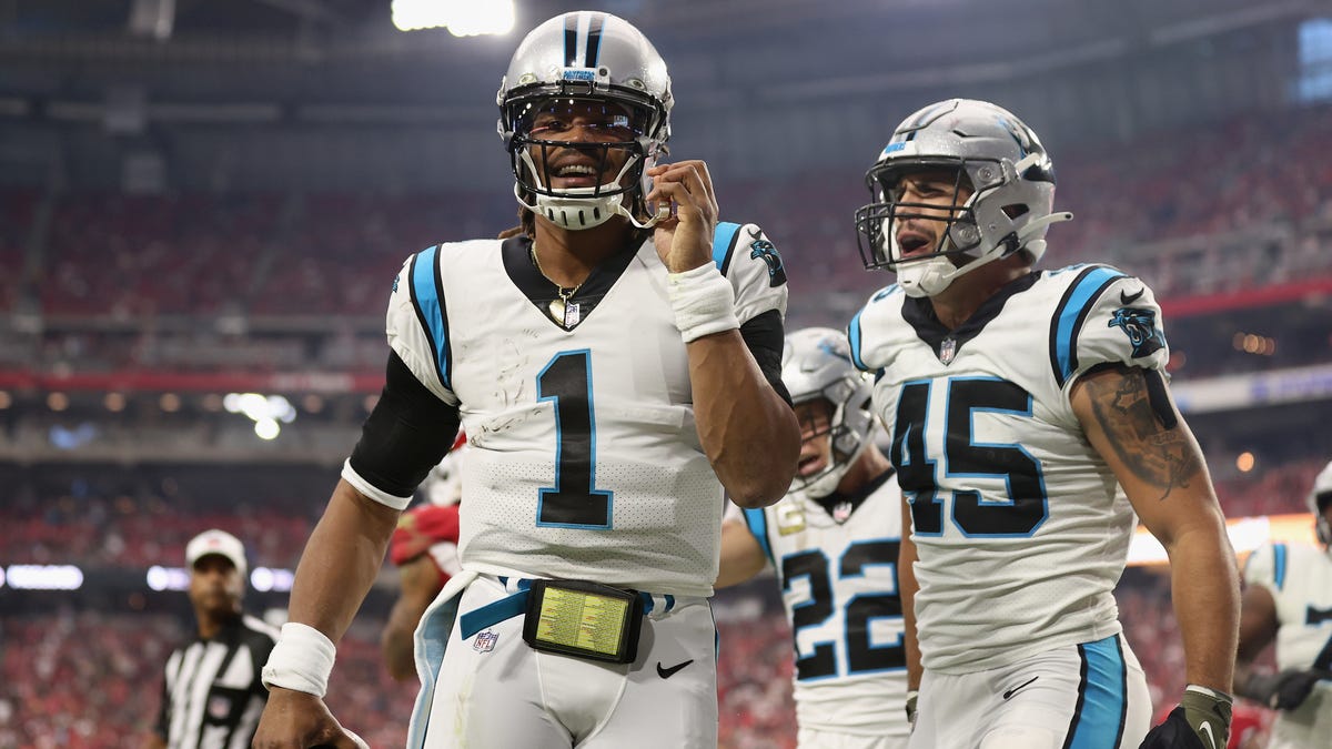 Quarterback Cam Newton of the Carolina Panthers reacts after scoring on a 2-yard rushing touchdown against the Arizona Cardinals during the first quarter of the NFL game at State Farm Stadium on November 14, 2021 in Glendale, Arizona.