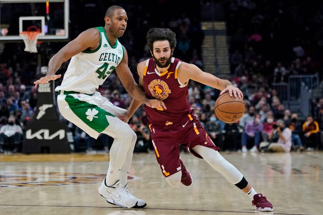 Cleveland Cavaliers' Ricky Rubio (3) drives against Boston Celtics' Al Horford (42) in the second half of an NBA basketball game, Monday, Nov. 15, 2021, in Cleveland. (AP Photo/Tony Dejak)