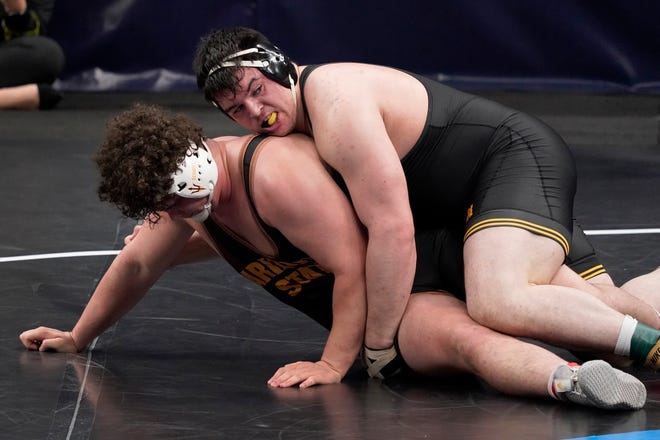 Iowa's Tony Cassioppi, right, takes on Arizona State's Cohlton Schultz during their 285-pound match in the quarterfinal round of the NCAA wrestling championships Friday, March 19, 2021, in St. Louis.