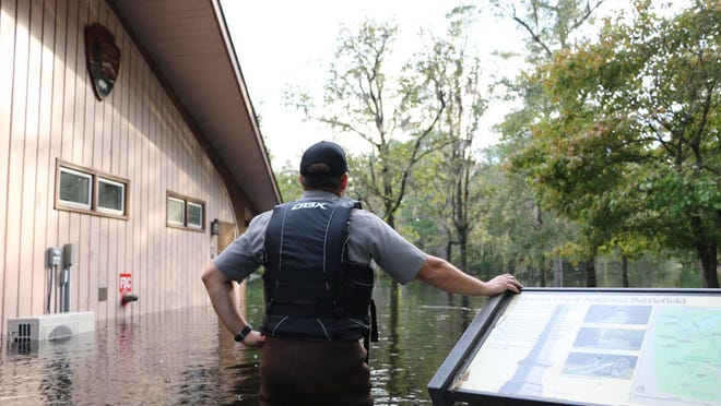 A National Park ranger surveys the flooding damage at Moores Creek National Battlefield after heavy rains from 2018's Hurricane Florence inundated the region.