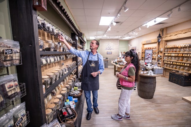 Lance and Sandie Boekenoogen operate The Spice & Tea Exchange located in Pier Park at Panama City Beach. Lance helps customer Dee Lynn, from Hollywood, Ca., find a tea in the store Monday, November 15, 2021.