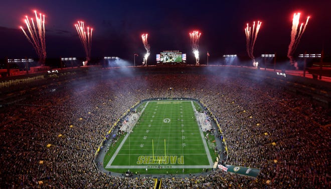 Fireworks go off during the National Anthem over Lambeau Field before the start of the Green Bay Packers game against the Detroit Lions on Sept. 20, 2021, in Green Bay, Wis. The Packers launched a stock sale on Tuesday to raise money for continued investment in the stadium.