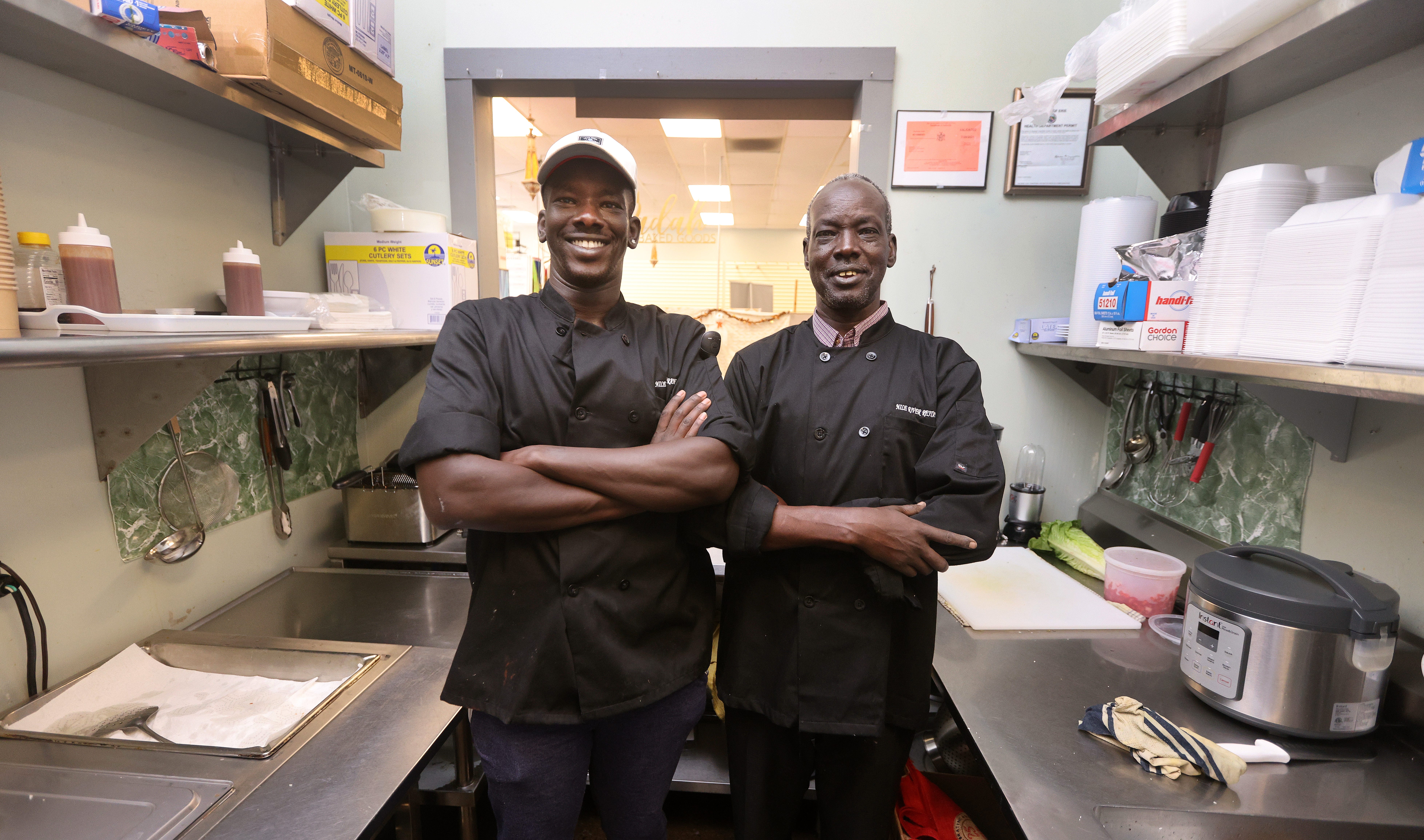 A father and son team cooks Sudanese cuisine at West Side Bazaar in Buffalo, N.Y.  Akec Aguer and his son Garang Doar are looking to grow from this space.