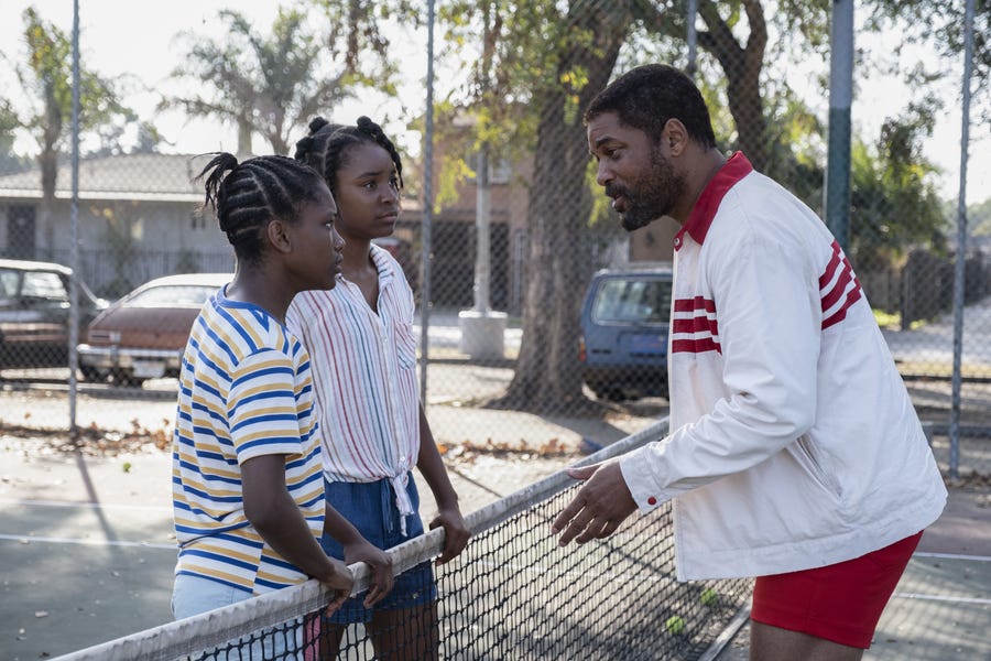 Richard Williams (Will Smith) coaches his daughters – and future tennis champs – Serena (Demi Singleton) and Venus (Saniyya Sidney) on the courts of Compton in "King Richard."