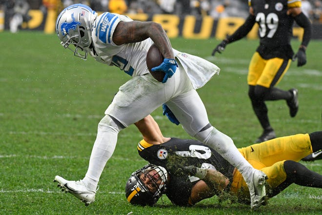 Detroit Lions running back D'Andre Swift, top, gets past Pittsburgh Steelers outside linebacker Alex Highsmith (56) during the second half of an NFL football game in Pittsburgh, Sunday, Nov. 14, 2021. (AP Photo/Don Wright)