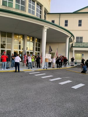 Protesters gathered outside a Flagler School Board meeting last year during a dispute over library books.