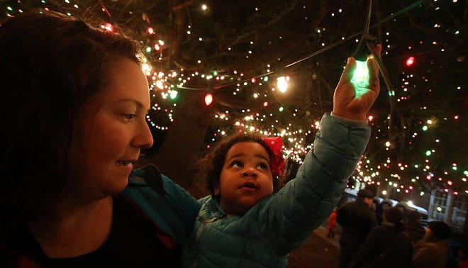 Two-year-old Olivia Gamble and her mother, Meghan Gamble, check out the lights during Christmas Town U.S.A.'s 19th Annual Tree Lighting held in front of the Pharr Family YMCA in McAdenville in 2019.