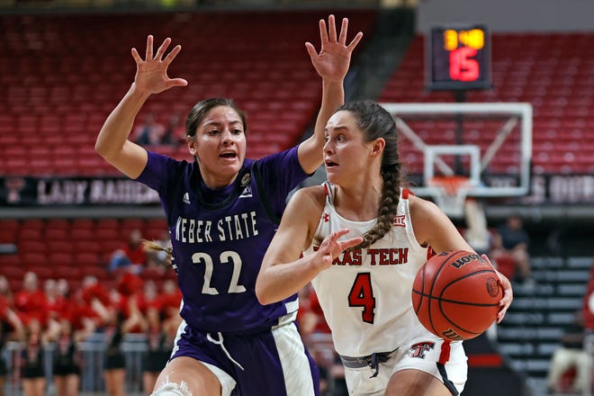 Texas Tech's Lexy Hightower (4) dribbles the ball around Weber State's Aloma Solovi (22) during the second half of an NCAA college basketball game on Tuesday, Nov. 16, 2021, in Lubbock, Texas.