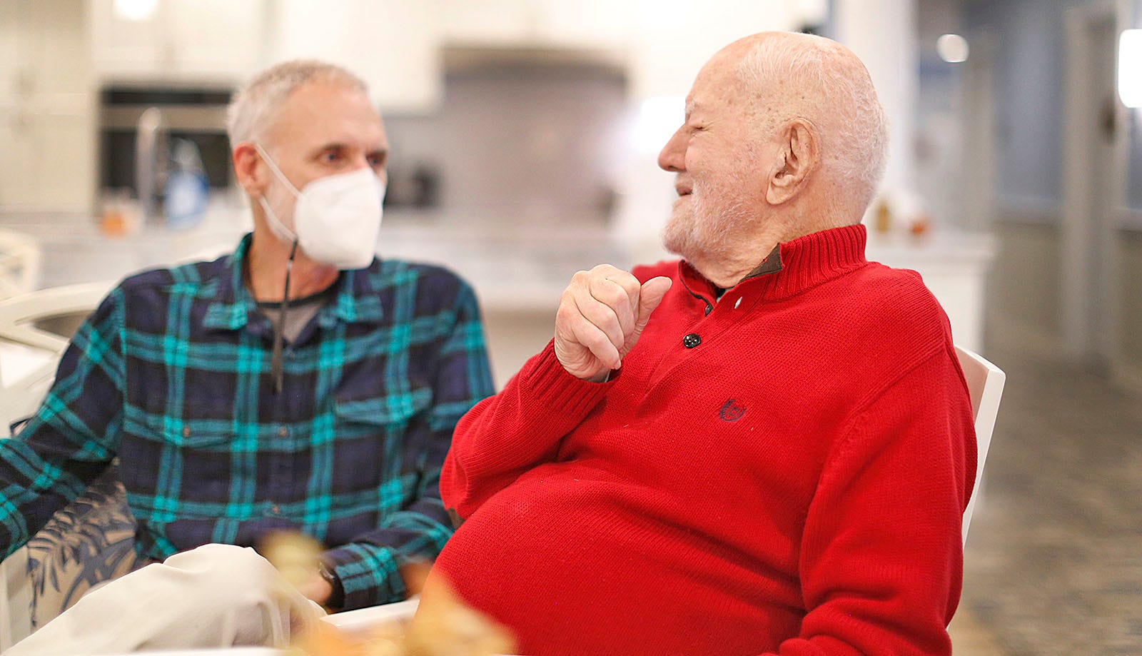 Ted Curtin, 95, right, talks with his son Ted Curtin Jr. at Duxbury House, part of the Village at Duxbury, on Wednesday, Nov. 17, 2021.