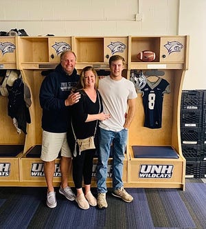 Barry Kleinpeter with his parents, Barry Sr. and Jennifer, in the locker room at New Hampshire, where Barry will be playing college football next year.