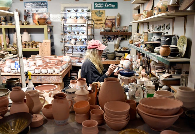Terry Plasket, resident potter at Wheaton Arts and Cultural Center in Millville N.J., paints pottery in his studio on Tuesday, Nov. 16, 2021.