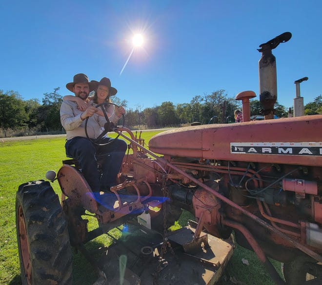 Benjamin Till and Tricha Porter's wedding incorporated lots of personal touches, including a tractor show. The bride and groom are pictured on his Farmall International 140, formerly used to mow the City Park in Smithville.