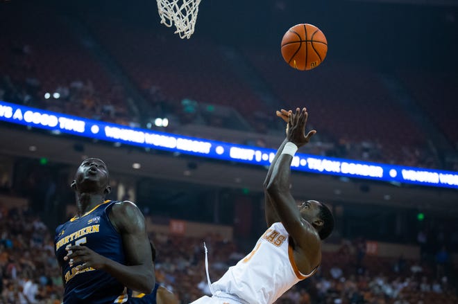 Texas guard Courtney Ramey (3) puts the ball up as he falls after a fast break ended in a collision with Northern Colorado forward Kur Jongkuch (15) during the first half of the Longhorn’s game against the Bears on Wednesday, Nov. 17, 2021 at the Erwin Center. 