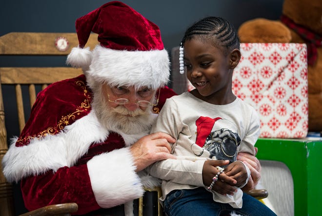 Jacey Scott tells Santa that she wants Shopkins for Christmas on Black Friday at Midtown Village in Tuscaloosa, Ala. on Friday, Nov. 23, 2018. [Photo/Jake Arthur]