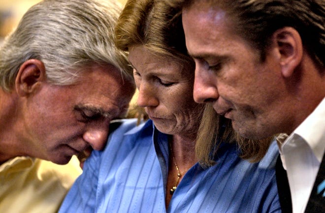 While reading an emotional statement to members of the press,  Suzanne Bromstrup is comforted by her husband, Paul Bromstrup, left, and Tim Stone, right, Tuesday, June 14, 2005.  The two families came together for the first time to make their first public statement about the car crash June 17, 2002 by teen driver Stephen Bromstrup that killed Sarah Stone and Alexandra Quaroni.