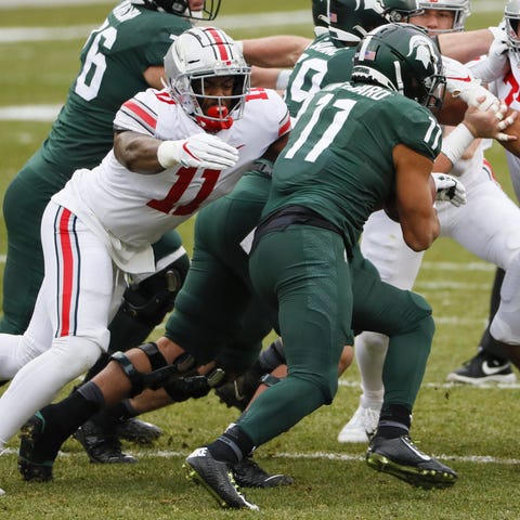 Ohio State defensive end Tyreke Smith attempts to 