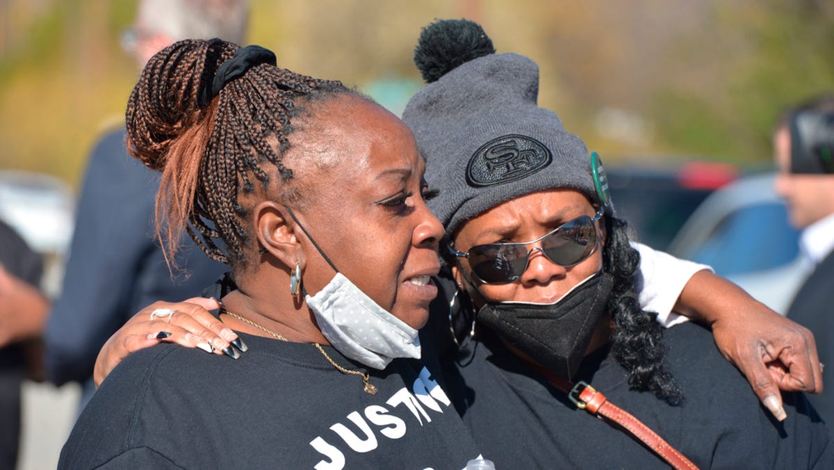 Family members of Julius Jones embrace outside Oklahoma State Penitentiary in McAlester, Okla., following Gov. Kevin Stitt's commutation, Thursday, Nov. 18, 2021. Gov. Stitt announced Thursday that he was commuting the 41-year-old Jones' sentence to life in prison with no chance of parole.
